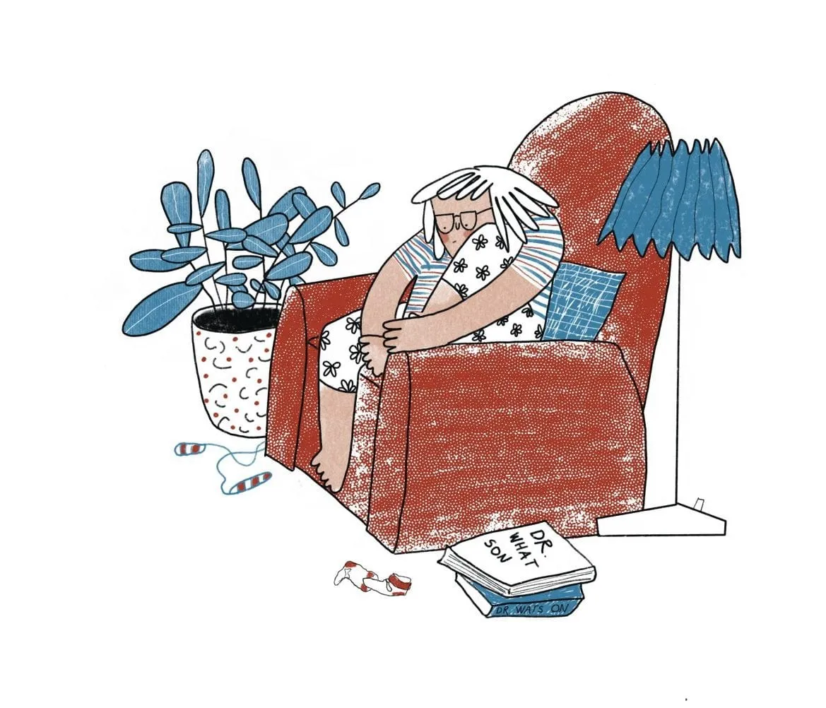 A white-haired girl curls up in a big red armchair beside a lamp and a stack of Dr Watson books