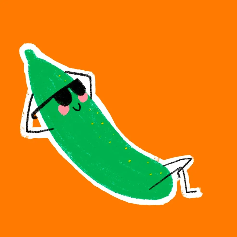 Long green cucumber lounging back in black sunglasses with one leg crossed
