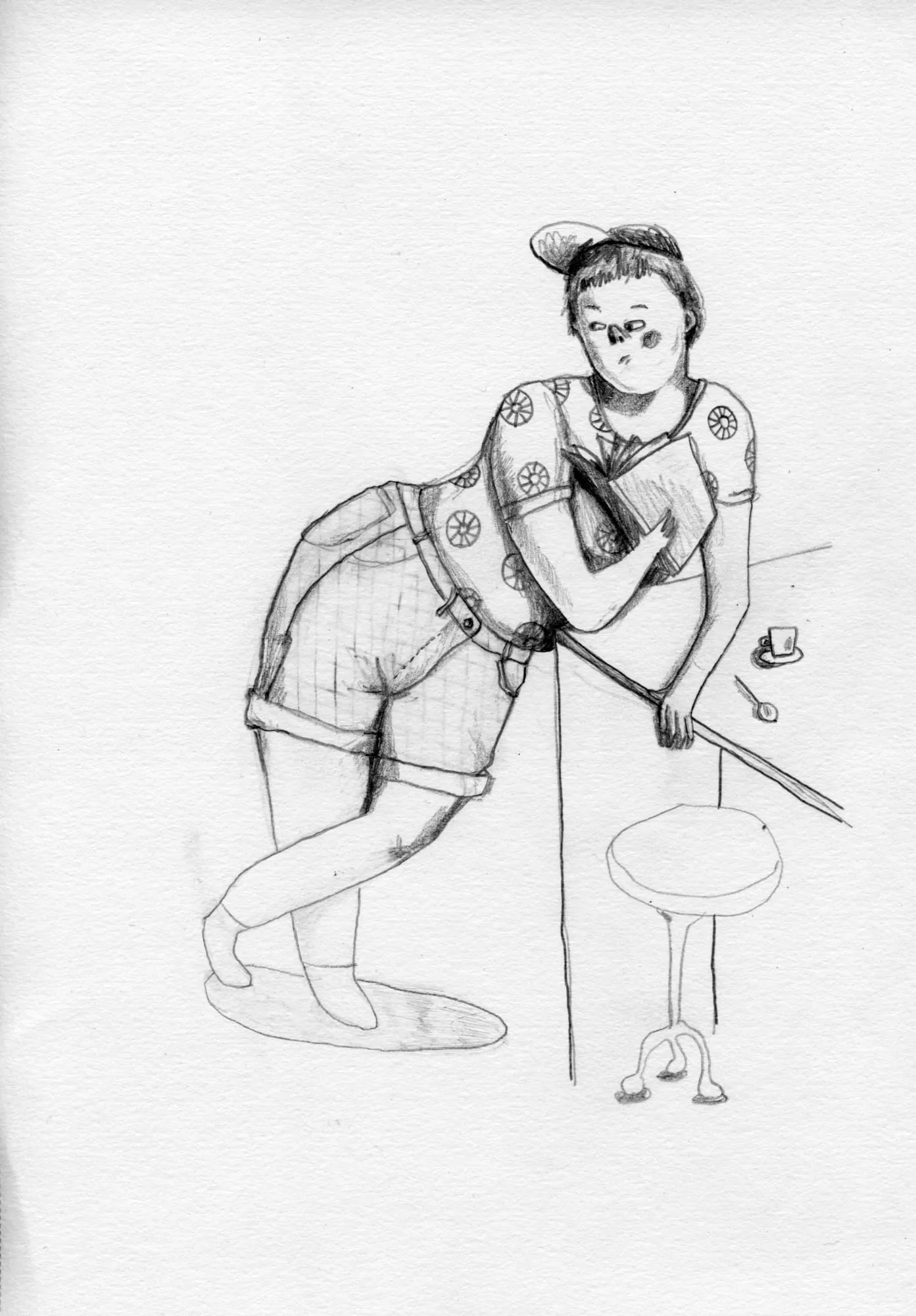 Woman in a cap and shorts hugs a book, leaning on a tall pole beside a stool with a teacup