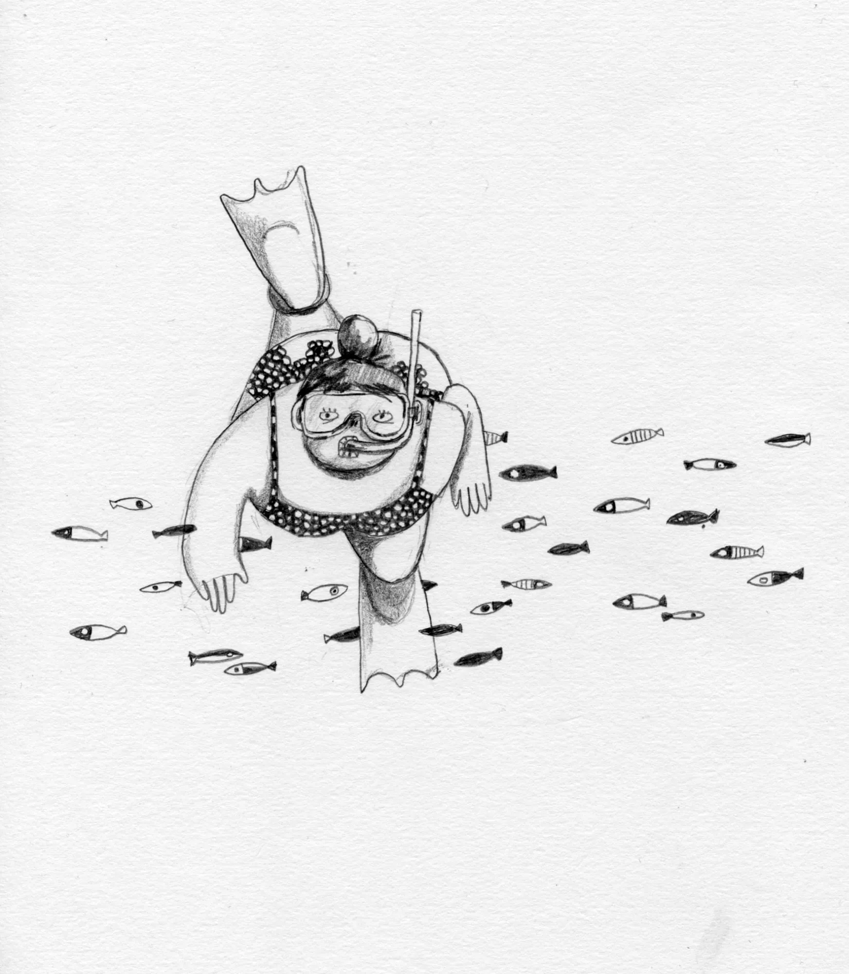 Snorkeller in mask and flippers dives head-first through a scatter of small striped fish