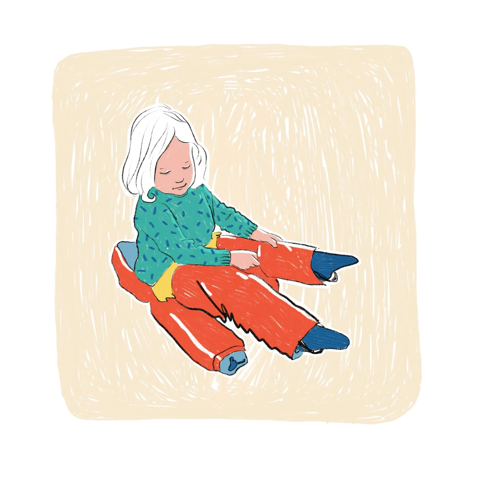 Child in a green speckled jumper sits on the floor pulling wide red trousers over blue socks