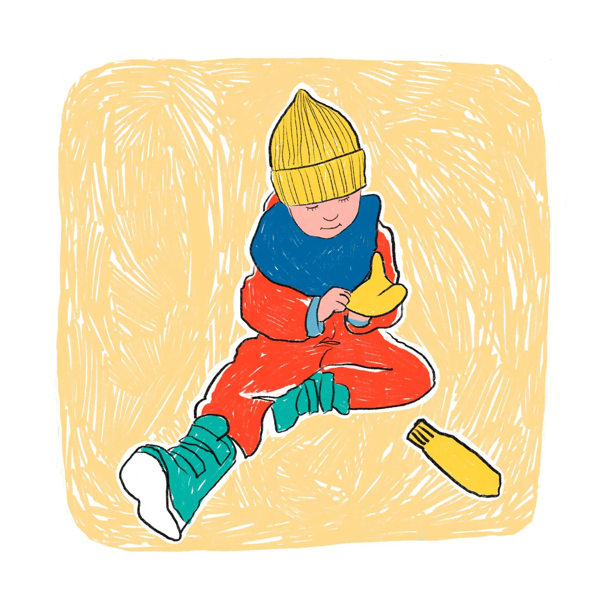 Sitting cross-legged in yellow beanie and blue snood, studying a yellow mitten